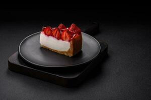 Delicious fresh cheesecake with strawberries, syrup and mascarpone cheese photo