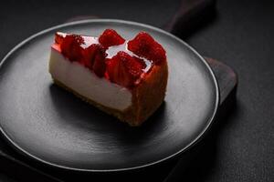 Delicious fresh cheesecake with strawberries, syrup and mascarpone cheese photo