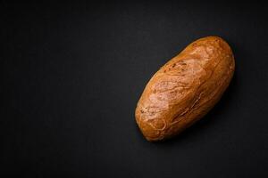 Delicious fresh crispy loaf of white bread with grains and seeds photo