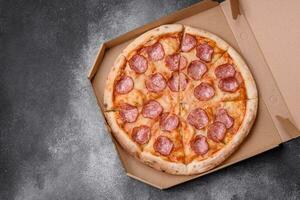 Tasty fresh pizza with salami, cheese, tomatoes, spices and salt photo