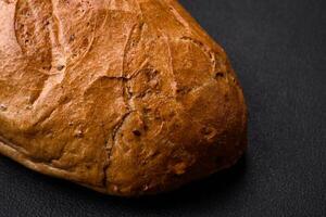 Delicious fresh crispy loaf of white bread with grains and seeds photo