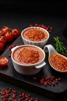 Delicious spicy tomato sauce with pepper, garlic, salt, spices and herbs photo