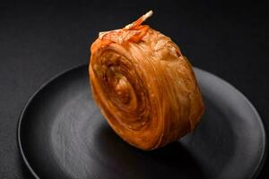 Round puff pastry croissant with citrus filling or New York roll photo