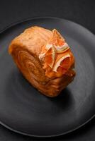 Round puff pastry croissant with citrus filling or New York roll photo