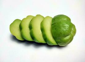 A few slices of chayote isolated on white background photo