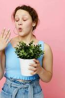 beautiful woman holding a pot with a flower isolated backgrounds unaltered photo