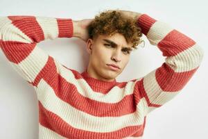 handsome guy in a striped sweater posing isolated background photo