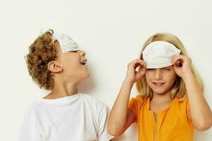 picture of positive boy and girl fun medical mask stand side by side close-up light background photo