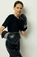 photo pretty girl in black sports uniform boxing gloves posing Lifestyle unaltered