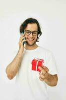 Cheerful man Red gift box telephone communication isolated background photo