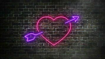 Pink or purple heart with arrow neon signboard on bricks wall background. Concept of love and symbol of cupid video