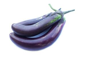 Organic purple eggplant fruits, isolated on white background. Concept, Thai agriculture vegetable crops, can be cooked for variety menu, sell at local market or restaurant. Edible plants. photo