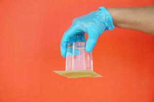 Closeup hand hold and turn  a glass of water over down. covered the glass with paper. Concept,  science experiment about air and liquid pressure. Easy science subject activity, education. photo