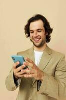 Cheerful man with a phone in hand beige suit elegant style Lifestyle unaltered photo