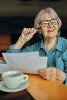 Senior woman documents work sheet of paper and pen Social networks unaltered photo
