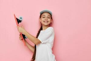 pretty young girl cap in white t-shirt skateboard Lifestyle unaltered photo