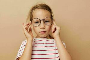 little girl wearing glasses striped t-shirt close up photo