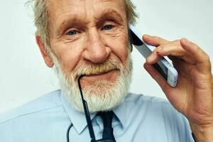 Senior grey-haired man in a shirt with a tie Finance and Investments Bitcoin light background photo