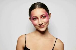 Sexy brunette woman pink face makeup posing attractive look light background unaltered photo