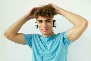 Attractive man in blue t-shirts headphones fashion isolated background photo