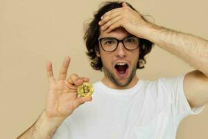 Attractive man with glasses gold bitcoin in hands Lifestyle unaltered photo