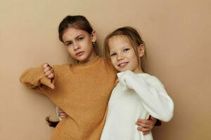 two cute little girls hug friendship childhood posing photo