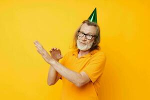 Photo of retired old man in a yellow t-shirt with a cap on his head fun cropped view