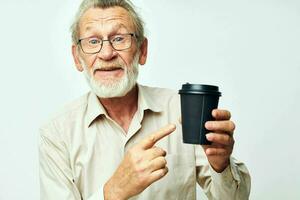 Portrait of happy senior man in a shirt and glasses a black glass cropped view photo