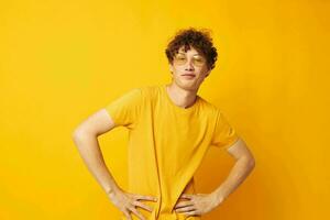 cute red-haired guy wearing stylish glasses yellow t-shirt posing yellow background unaltered photo