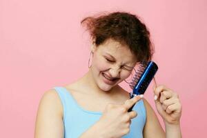 Young woman in blue t-shirts comb with hair emotions isolated background unaltered photo