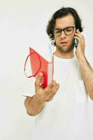 Cheerful man talking on the phone red notepad isolated background photo