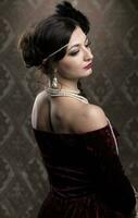 Retro woman portrait. Luxurious lady in vintage style from 20s or 30s. Photo of a girl in vintage style.