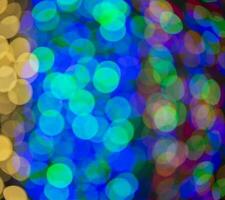 Multi-colored large bokeh spots of blue, yellow and orange. Bokeh from a Christmas garland. photo