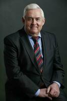 Portrait of an elegant elderly man in a suit and tie. photo