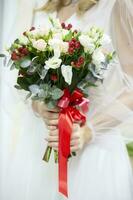 Bridal bouquet in hands. Wedding day.Flowers in the hands of the bride photo