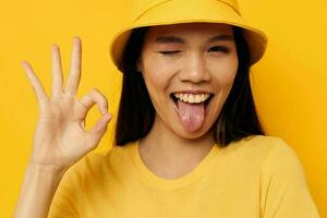 Portrait Asian beautiful young woman in a yellow t-shirt and hat posing emotions Lifestyle unaltered photo