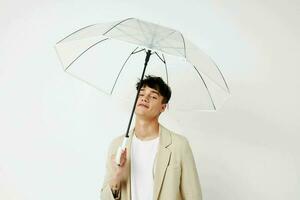 handsome guy transparent umbrella a man in a light jacket isolated background unaltered photo