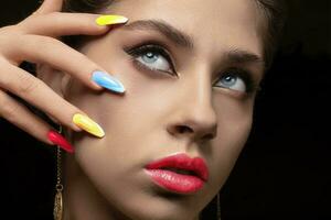 Beauty girl portrait with bright makeup and colorful rainbow nail polish. Colorful nails. photo