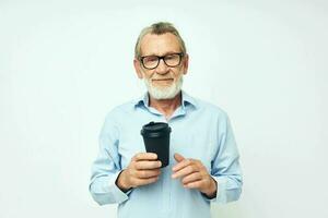 Senior grey-haired man with glasses and shirts disposable glass isolated background photo