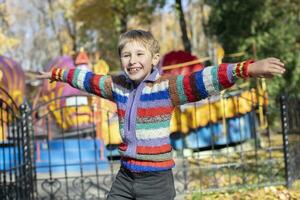 Little boy having fun outdoors in the park. Cute happy baby boy outdoors. Happy child posing outdoors photo