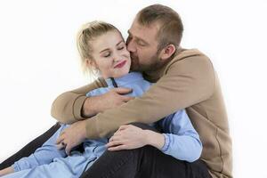 On a white background, a man gently kisses a woman. Husband and wife. photo