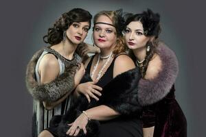 Three women in vintage style. People are stylized for the era of the 20s or 30s. photo