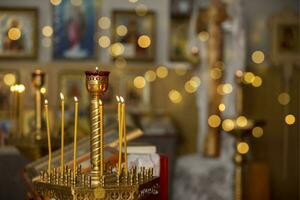 Candles on the background of the church interior and golden bokeh. photo