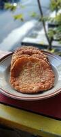 Crispy fried pancakes on a plate in the morning. Food made from a mixture of eggs, rice, spring onions fried in hot oil. It looks like an omlete with extra rice photo