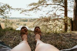 A close-up photo of the intentions of women's legs. The concept of a tourist trekking expedition. View from the tent to the landscape