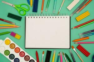 Back to school soon. buying stationery, flatlay, a place to copy your text or advertising on a white tablet. Bright background. photo