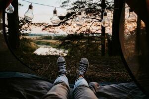 A close-up photo of the intentions of women's legs. The concept of a tourist trekking expedition. View from the tent to the landscape