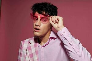 handsome guy pink shirt and glasses jacket fashion elegant style pink background unaltered photo