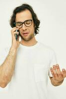 Attractive man telephone communication hand gesture light background photo