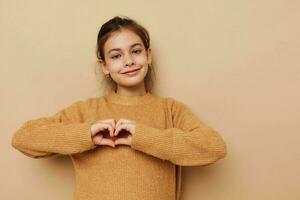 pretty young girl in sweater posing hand gestures isolated background photo